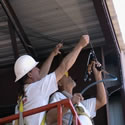 Instlling bird netting on or under canopies and structures takes team work and the right tools